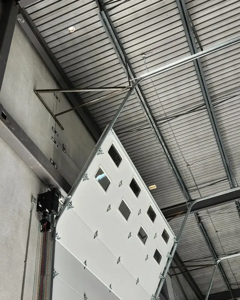 Large vertical-lift industrial door inside a steel warehouse